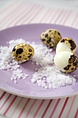 Unshelled and half-shelled quails' eggs with sea salt