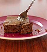 Chocolate brownie on a plate with cake fork