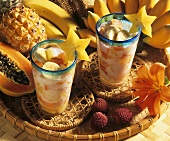 Exotic fruit salad with coconut milk in two glasses