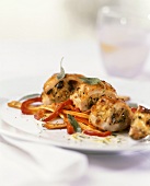 Stuffed chicken breast on vegetables with sage