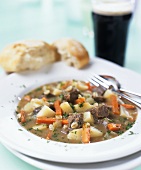 Irish stew with bread and a glass of Guinness