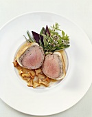 Veal fillet in pastry on chanterelles with bunch of herbs