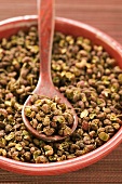 Szechuan pepper in bowl with spoon