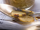 Slices of pretzel on spoon (close-up)