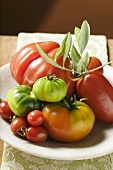 Assorted tomatoes with olive sprig on plate