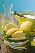 Fresh lemons with leaves, lemon juice and sugar