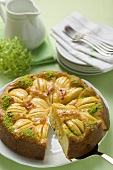 Apple cake with chopped pistachios, a slice cut