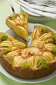Apple cake with chopped pistachios, a slice cut