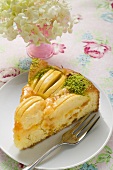 Slice of apple cake with chopped pistachios on plate