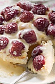 Cherry tart with icing sugar and custard