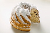 Gugelhupf with icing sugar, a slice taken