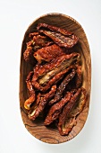 Dried tomatoes in wooden bowl