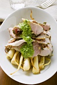 Turkey with herb sauce on root vegetables