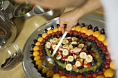 Pouring gelatine over fresh fruit
