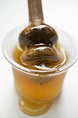 Honey in small bowl with honey dipper