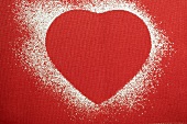 Red heart shape outlined in icing sugar
