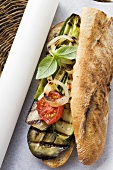 Grilled vegetables and basil in baguette