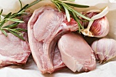 Raw pork chops, rosemary and garlic