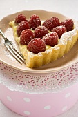 Piece of raspberry tart with vanilla cream