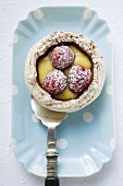 Meringue shell with raspberries, vanilla cream & icing sugar