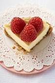 Piece of cheesecake with raspberries