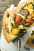 Pizza with cherry tomatoes, capers & rosemary (slice on server)