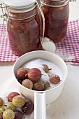Gooseberries with sugar, gooseberry jam in jars