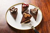 Four pieces of chocolate tart with different decorations