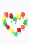 Coloured jelly sweets forming heart with the words 'Sweet heart'