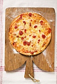 Whole pizza Margherita on chopping board