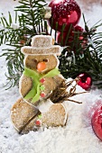 Spiced pastry snowman in winter landscape
