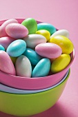 Coloured sugared almonds in pink bowl