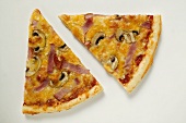 Slices of American-style ham and mushroom pizza