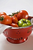 Various types of tomatoes in a colander