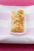 Almond finger with jam in a paper case