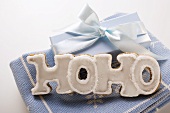 The word 'HOHO' in gingerbread with white icing, gift