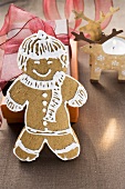 Gingerbread man in front of Christmas gifts