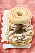 Bagel filled with pork fillet, capers & honey mustard relish