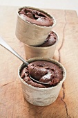 Three small chocolate soufflés filled with chocolate sauce