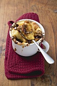 Chocolate bread and butter pudding in cup with spoon
