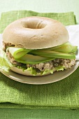 Bagel filled with avocado, tuna salad and capers