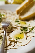 Cep carpaccio with olive oil and herbs