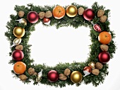 Fir sprigs, baubles and nuts forming a Christmas frame