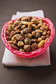 Mixed nuts to nibble in pink basket