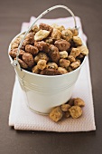Mixed nuts to nibble in white bucket