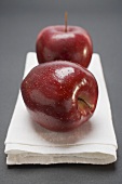 Two red apples, variety Stark, on linen cloth
