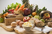 Still life with vegetables, fruit, eggs, butter, nuts, baguette