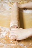 Child's hands rolling out pastry