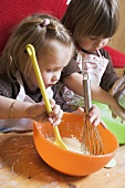 Two children baking