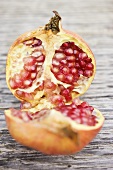 Pomegranate, halved, on wooden background